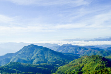 Fototapeta premium Scenic Mountain Landscape with Blue Sky and Layers of Misty Hills
