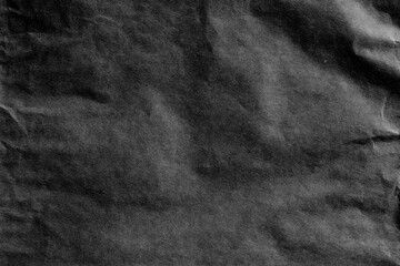 Naklejka premium Black crumpled paper texture closeup