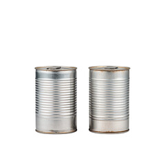 Two vintage tin canisters connected by a long string creating a simple communication device representing nostalgia.