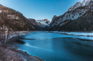 The Dachstein glacier reflecting in the Gosau lake in Austria at sunset in winter
