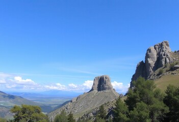 Obraz premium Majestic Mountain Landscape with Dramatic Rock Formations under a Vivid Blue Sky A Breathtaking View of Nature's Majesty