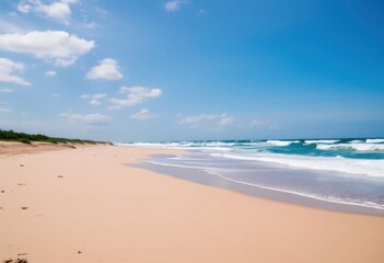 Fototapeta premium Serene Coastal Scene Sandy Beach Meets Turquoise Ocean Waves under a Summer Sky