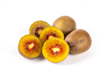 Red kiwi, Sweet bright red colored kiwi fruits, whole and sliced, on kitchen table copy space