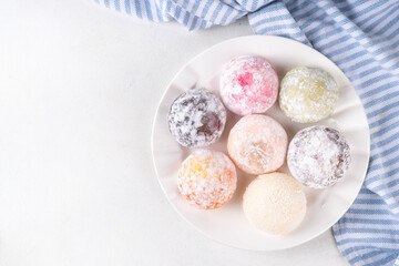 Various colorful fruit and berry mochi assortment. Traditional Japanese ice cream mochi, sweet dessert in rice dough, copy space