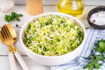 Spring cabbage salad, vegan healthy diet vegetable food, salad with spring cabbage, parsley, green onions, olive oil for dressing