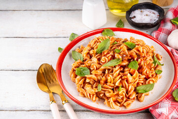 Fusilli pasta with bolognese sauce, with ground beef, mushrooms, tomatoes and basil. Traditional...