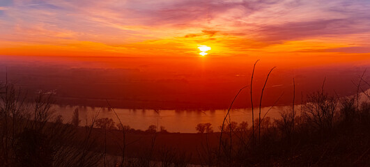 Winter sunset or sundowner with reflections at Mount Bogenberg, Bogen, Danube, Straubing-Bogen, Bavaria, Germany
