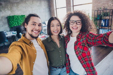 Diverse group of young professionals collaborating in a modern office setting, captured in a candid moment of teamwork and camaraderie