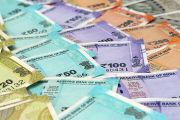 Rows of colorful Indian rupee banknotes (INR) of different values. Concept of cash savings, financial profit and security, Indian economy.