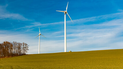 Winter landscape on a sunny day with wind power plants at Kugl, Landau, Isar, Bavaria, Germany