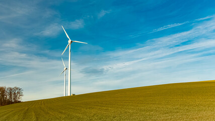 Winter landscape on a sunny day with wind power plants at Kugl, Landau, Isar, Bavaria, Germany