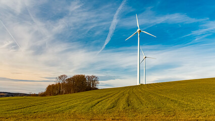 Winter landscape on a sunny day with wind power plants at Kugl, Landau, Isar, Bavaria, Germany