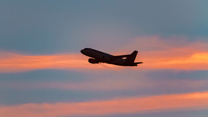 Summer sunset or sundowner view with a jet airplane at Munich airport, MUC, Freising, Bavaria, Germany
