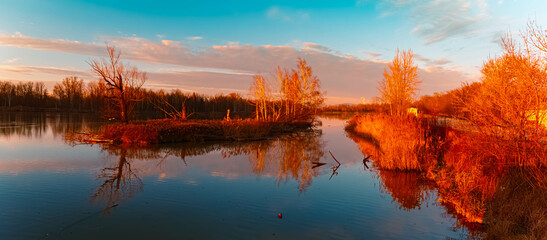 High resolution stitched winter sunset or sundowner panorama with reflections near Niederpoering,...