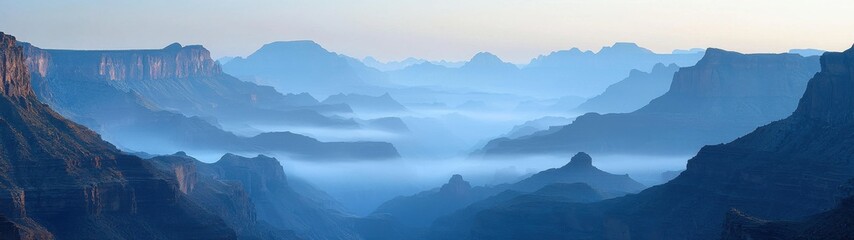 Fototapeta premium The stunning grand canyon is blanketed in soft fog, presenting a layered vista of nature's majesty.