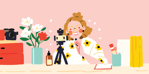 A cheerful content creator smiles brightly as she begins her broadcast, surrounded by flowers, a camera, and other tools of her trade, on a softly colored backdrop.