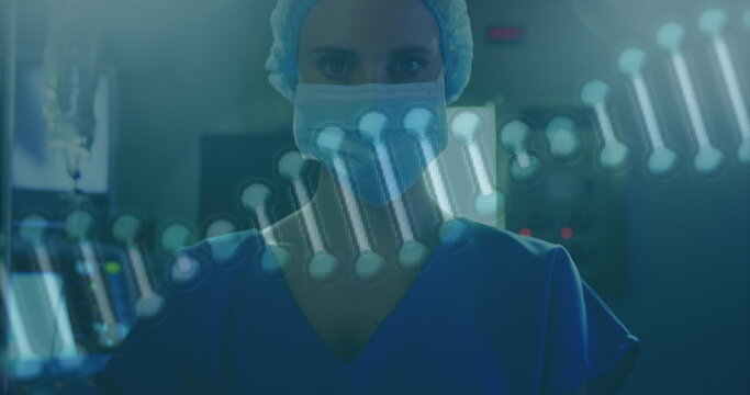 Image of rotating dna over caucasian female surgeon in face mask