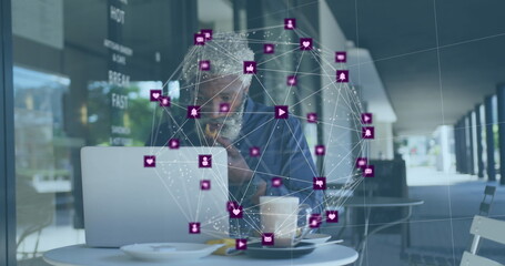 Image of network of connections with icons over senior african american man with laptop