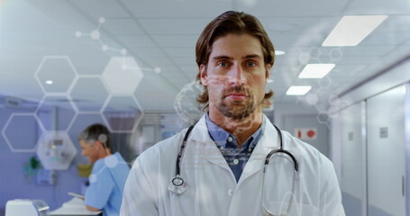 Image of caucasian male doctor in hospital over data processing