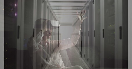 Image of women using vr headset over server room