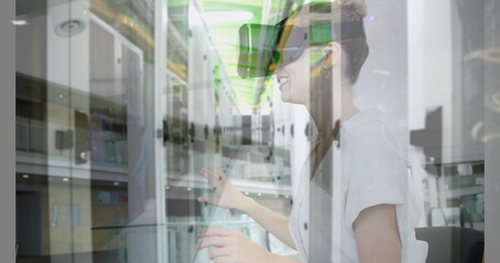 Image of women using vr headset over server room
