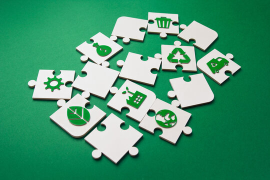 Environmental Puzzle Pieces with Green Sustainability Icons. puzzle pieces featuring green environmental icons arranged on a green background, symbolizing connected sustainability solutions.