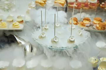 Buffet table at a banquet or celebration. Various canapes, fruits and cakes
