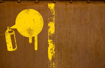 Graffiti spray can stencil on the rusty wall