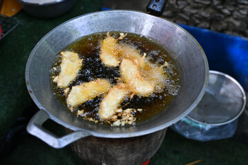 Fried bananas in hot oil in a pan