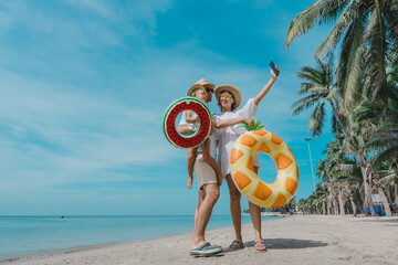 
 Link ×Title:
Happy family - father, mother, baby son walk with fun along edge of sunset sea surf on black sand beach. Active parents and people outdoor activity on summer vacations with children