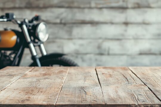 Empty wooden table presenting stylish biker accessories in rustic garage setting