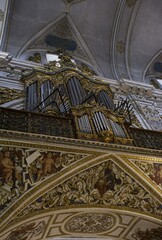 Seville, Spain - Mar 23, 2025: Walking in Seville. Real Parroquia de Santa Maria Magdalena. Streets, buildings. Lifestyle in the urban area. Cloudy spring day. Selective focus