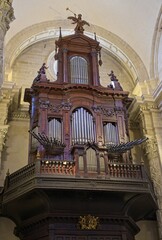 Seville, Spain - Mar 23, 2025: Walking in Seville. Collegiate Church of the Divine Savior. Streets, buildings. Lifestyle in the urban area. Cloudy spring day. Selective focus