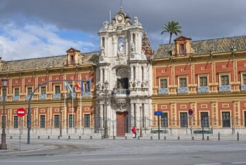 Seville, Spain - Mar 23, 2025: Walking in Seville. San Telmo Palace. Streets, buildings. Lifestyle in the urban area. Cloudy spring day. Selective focus