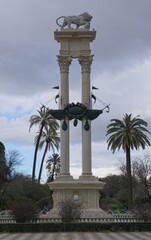 Seville, Spain - Mar 23, 2025: Walking in Seville. Christopher Columbus Monument. Streets, buildings. Lifestyle in the urban area. Cloudy spring day. Selective focus