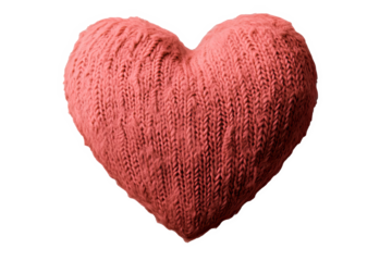 Soft knitted heart pillow in a coral color, perfect for home decoration and cozy atmospheres.