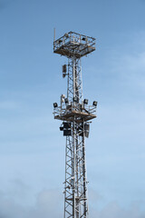 Tower with floodlights and communication equipment