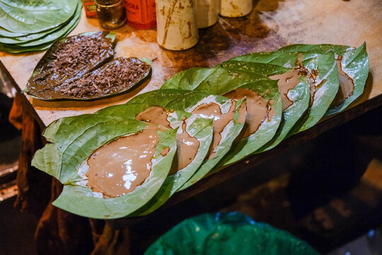 Traditional Indian Paan Preparation on a Street Stall &ndash; Betel Leaf with Lime Paste and Areca Nut