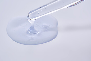 Pipette with delicate blue serum close-up.