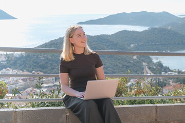 Remote Work,digital nomad enjoys remote work with a laptop in a scenic mountain setting.freedom of...