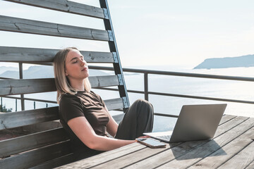 Remote Work,digital nomad enjoys remote work with a laptop in a scenic mountain setting.freedom of...