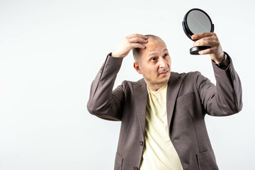 Naklejka premium Mature man and hair loss issue. Man Worried For Alopecia Checking Hair For Loss.