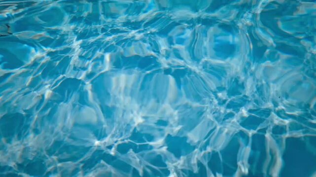 video of the constant movement and ripples of swimming pool water on a sunny day with light refraction recreation background with sound