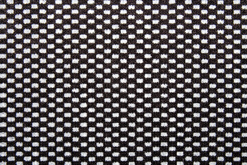 The texture is made of black and white fabric in a checkerboard pattern.The checkerboard background is made of fabric.Nylon black texture in a white square.
