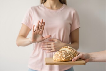 Woman refusing sesame bread with hand gesture, holding stomach, on plain background, expressing gluten intolerance or dietary concern. Ai generative