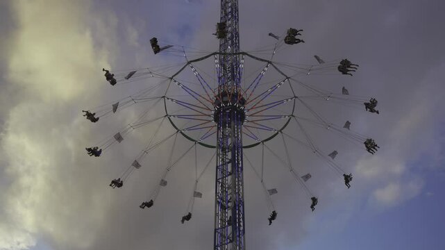 Star Flyer is worlds largest portable swing or chain carousel, standing at impressive height. Popular attraction at Oktoberfest in Munich, Bavaria, offering riders thrilling view of festival grounds. 