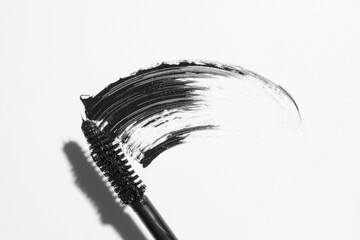 swatch of black ink with a tassel on a white background