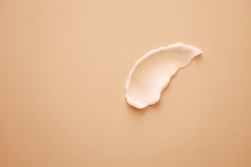 the swatch cream is white on a light beige background with a thick consistency
