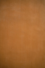 Orange background of a painted wall made of concrete / cement