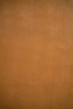Orange background of a painted wall made of concrete / cement